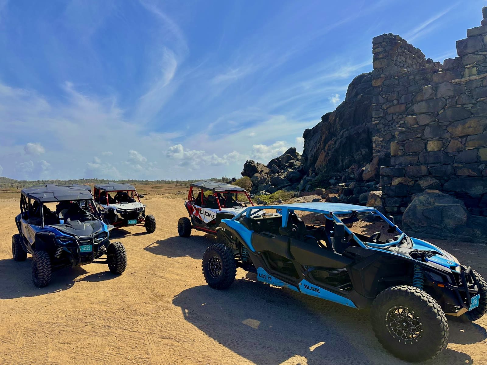 UTVs parked beside the stone ruins of a gold mine