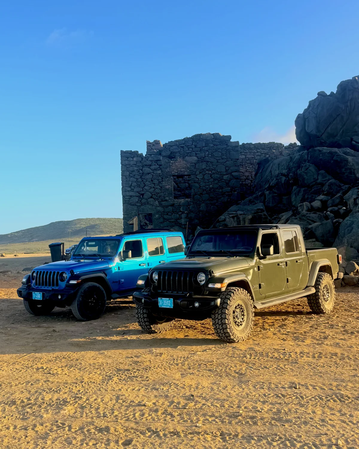 Aventurova Jeep Wrangler and Jeep Gladiator parked in front of old stone ruins
